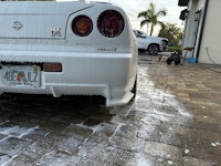 a white nissan gtr parked on a driveway